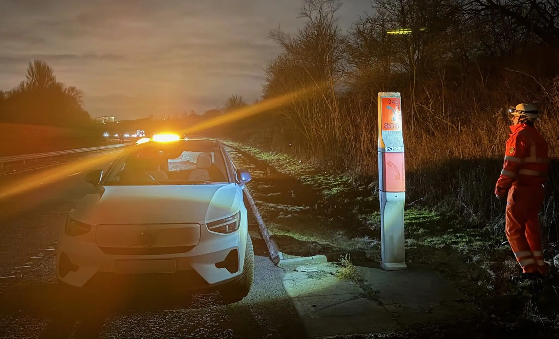 Car next to phone point on road